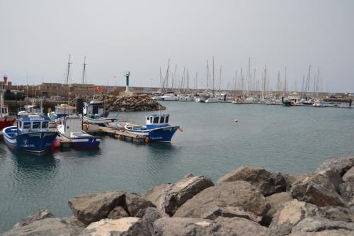a group of boats are docked in a harbor at Casa Mararía in Gran Tarajal