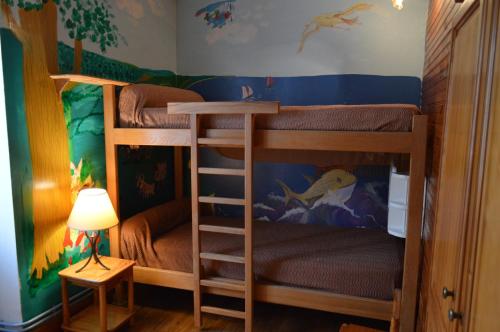 a bedroom with two bunk beds with a disney mural at Le Tilleul in Anglars