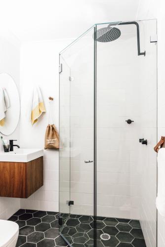 a bathroom with a shower and a sink at Veriu Central in Sydney
