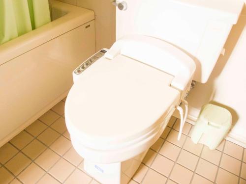 a bathroom with a toilet with the lid up at Irou in Tonosho