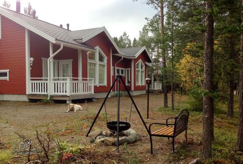 a red house with a swing in front of it at LevinSatu: SeLevi and TaLevi Apartments in Levi