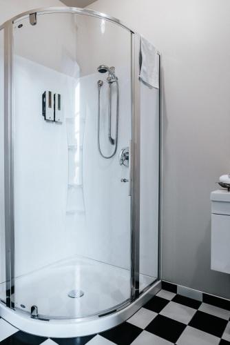 a shower with a glass enclosure in a bathroom at The Grange B&B in Christchurch