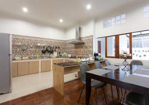 a kitchen with a table and a dining room at Sirinan Villa Nimman ChiangMai in Chiang Mai