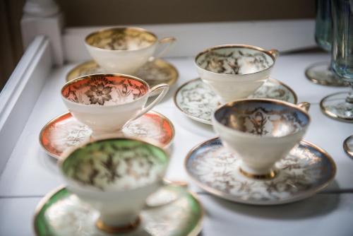 a group of tea cups and saucers on a table at The Grange B&B in Christchurch