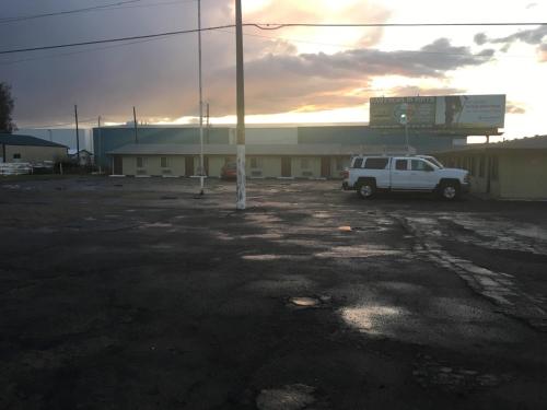 a white truck parked in front of a building at Oregon Trail Motel in Ontario
