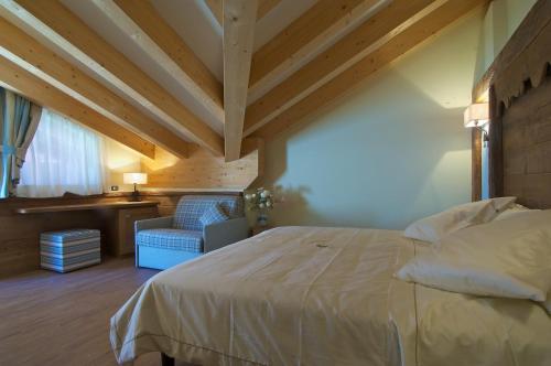 Postel nebo postele na pokoji v ubytování Hotel Garni Vittoria