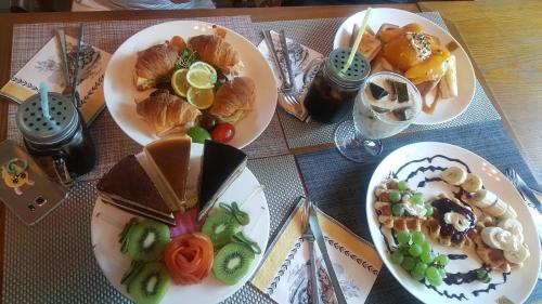 a table with three plates of food on it at Shinevalley Pension & Hotel in Pyeongchang 