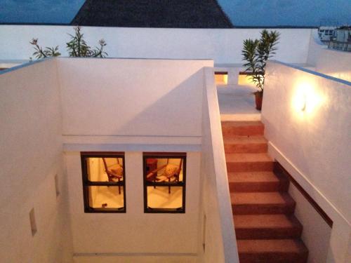 a staircase in a house with two windows at Andavelo House in Lamu