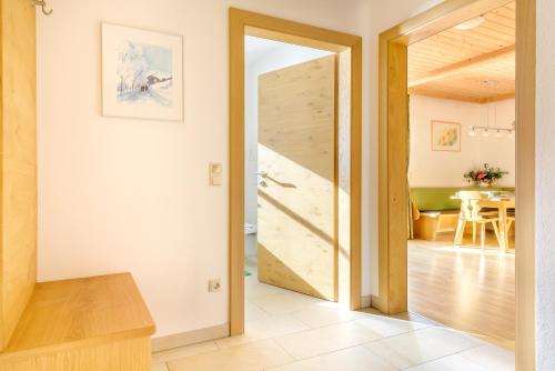 a wooden door in a room with a dining room at ARCHE Hof Öbristhof in Kleinarl