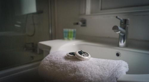 a bathroom with a white towel next to a sink at The Roman Gathering in Chester