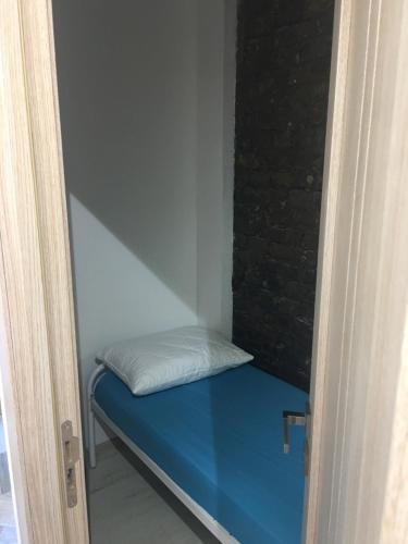 a small room with a bed with a blue mattress at Hostel Train Station in Kyiv
