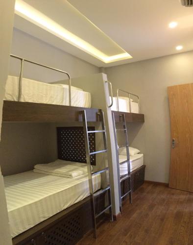 a room with two bunk beds and a hallway at The Alley Hostel in Nha Trang
