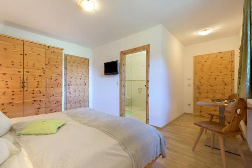 a bedroom with a bed and a walk in shower at ARCHE Hof Öbristhof in Kleinarl