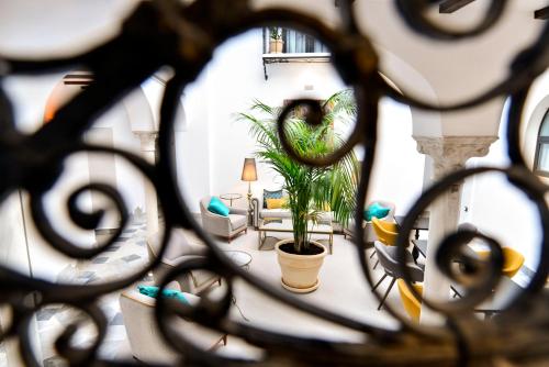 a view of a living room with a plant at Legado Alcazar Hotel in Seville