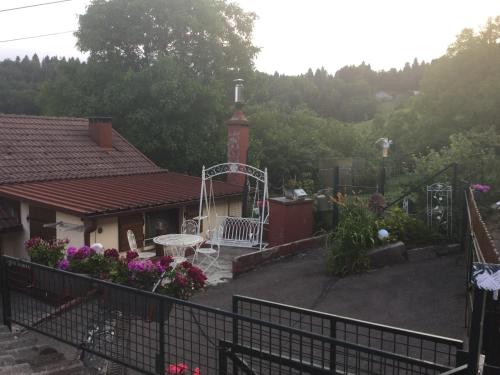 a house with a gate and a garden with flowers at La Ferme de Là-haut B&B in Le Haut-du-Them