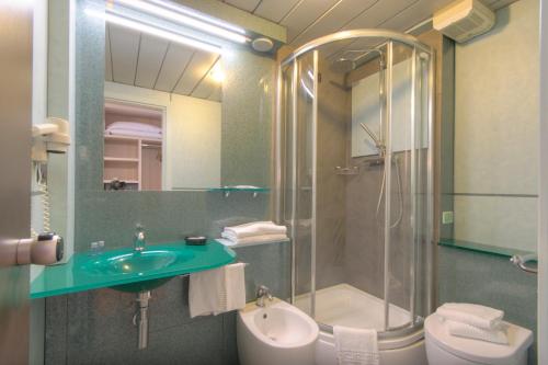 a bathroom with a sink and a shower and a toilet at Hotel Palace del Conero in Osimo