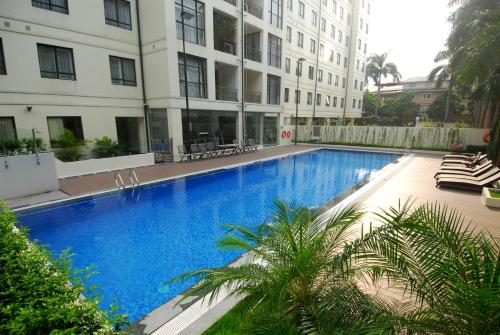 a large blue swimming pool next to a building at Mayfair Hanoi in Hanoi