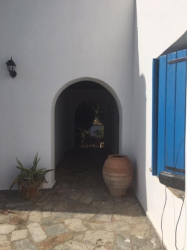 a hallway with a vase next to a white wall at Aiolos in Skala