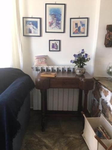 a bedroom with a table with flowers on the wall at Aiolos in Skala