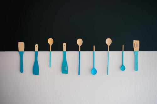 a group of forks and spoons hanging on a wall at Vienna House Easy by Wyndham Trier in Trier