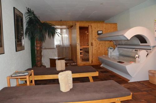 a living room with two tables and a stove at Hotel Regina Terme in Leukerbad