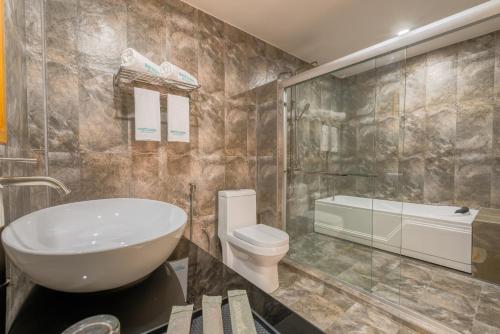 a bathroom with a white sink and a toilet at White Sand Dhigurah in Dhigurah