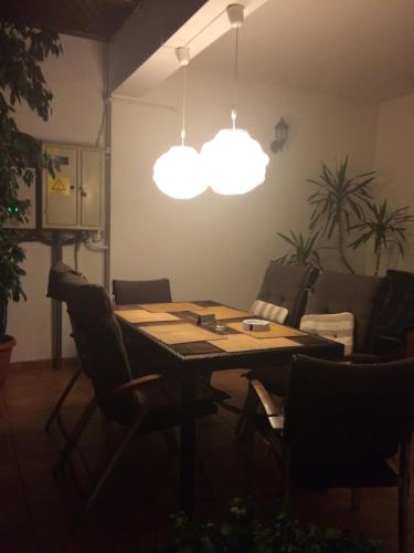 a dining room with a table and two lights at Hotel-Restaurant Siesta Balea in Cumpăna