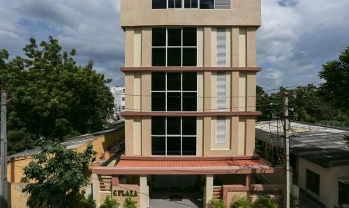 Un edificio alto con una torre sopra. di Treebo Trend C Plaza a Vijayawāda