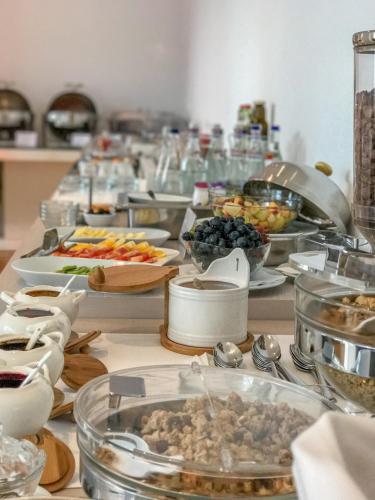 a buffet with many dishes of food on a table at Hotel Satu Mare City in Satu Mare