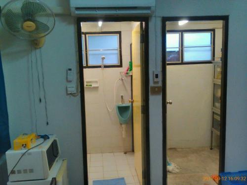 a bathroom with a toilet and a room with a shower at Social Style Culture in Bangkok