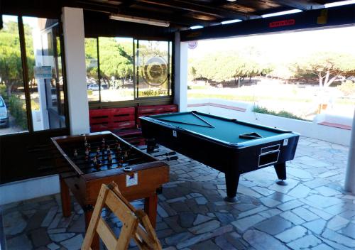 a room with a pool table and a chess board at Parque de Campismo Orbitur Sagres in Sagres
