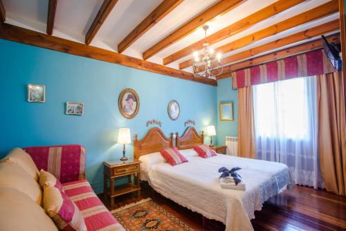 a bedroom with a bed and a couch at Posada Rio Cubas in Cubas