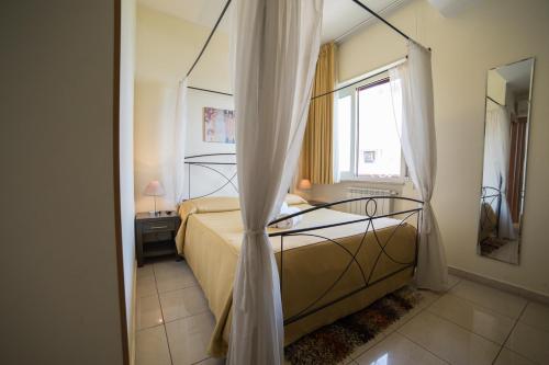 a bedroom with a bed and a window at La Terrazza in Aci Castello