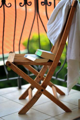 a wooden rocking chair with a book on it at Penzion Tematin in Piešťany