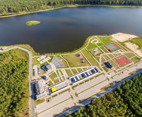 an aerial view of a park next to a lake at Kurpiowska Kraina in Wydmusy