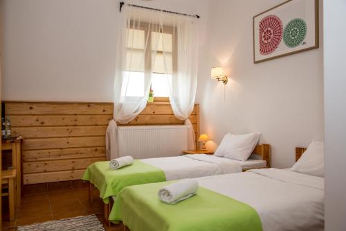 a hotel room with two beds and a window at Kurpiowska Kraina in Wydmusy