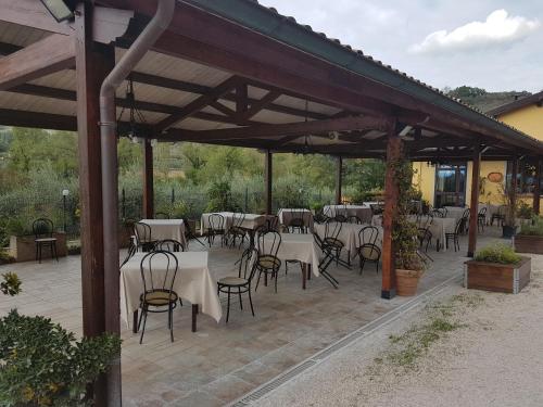 an outdoor patio with tables and chairs at Hotel Ponte San Vittorino in Assisi