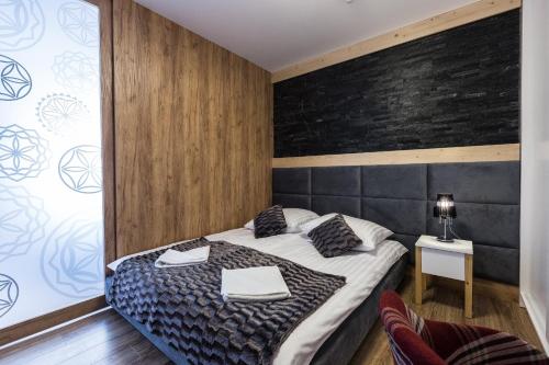 Postel nebo postele na pokoji v ubytování Aparthotel Góralski Spa & Restaurant