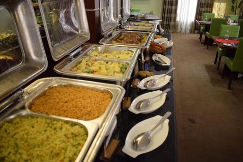a buffet line with many different types of food at Grand Pela Hotel & Suites in Abuja