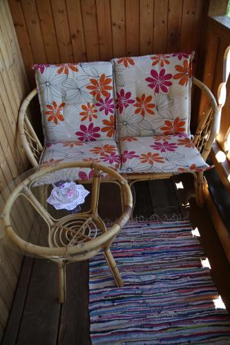 a chair with a pillow and a table on a rug at Urlaub am Lacknerhof - Familie Klocker in Liebenfels