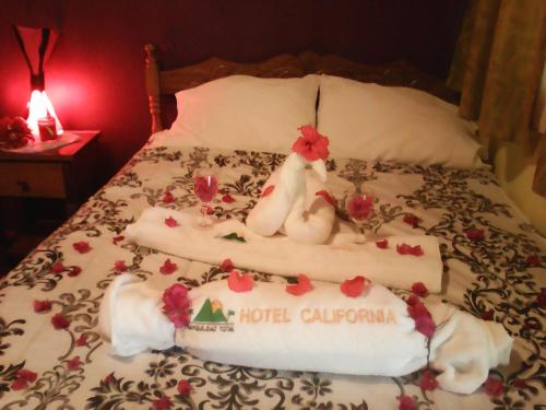 a bed with two chicken decorations on it at Hotel California in San Jorge