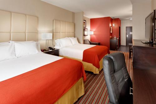 a hotel room with two beds and a television at Holiday Inn Express & Suites Northeast by IHG in York