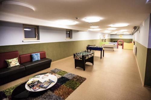 a living room with a couch and a table at Aktivhotel Tuxerhof in Zell am Ziller