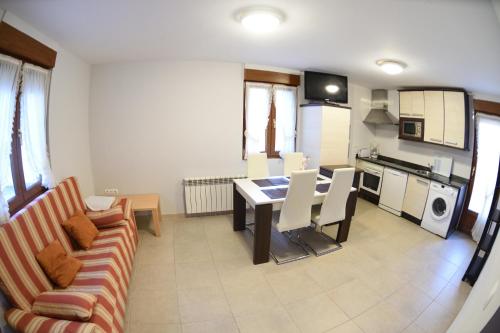 a living room with a couch and a table at Apartamentos Rurales Los Solares in Mogro