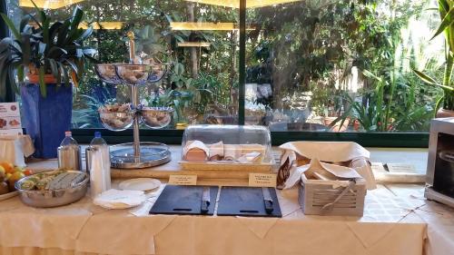 a table with cheese and other food items on it at Hotel Europa Beach Village in Giulianova