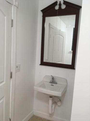 a bathroom with a sink and a mirror on the wall at Chinatown Hotel Chicago in Chicago