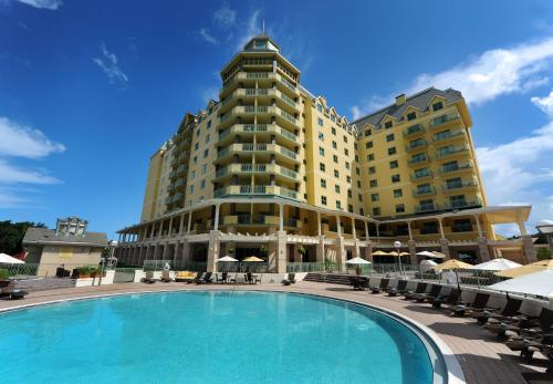 a hotel with a large swimming pool in front of a building at World Golf Village Renaissance St. Augustine Resort in St. Augustine