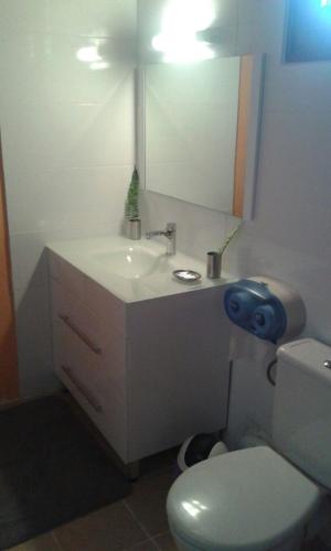 a bathroom with a white sink and a toilet at Holiday Home Villa Kay Malouz in Saint-Joseph