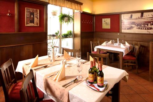 a restaurant with two tables and two bottles of wine at Penzion Budvarka in Hodonín