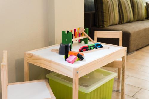 a table with a toy train on it in a living room at Villa Aurelia Old Town in Kavala